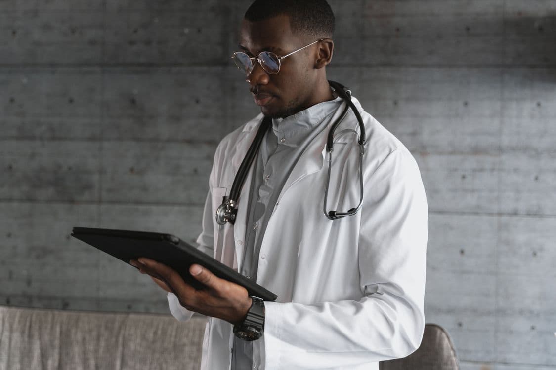 A physician reviewing a tablet